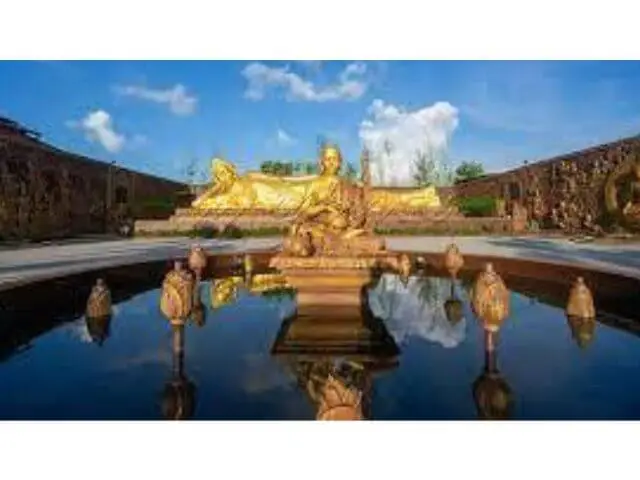 Sleeping Buddha statue in Bintan with peaceful expression surrounded by greenery